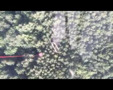 Dropping a bucket of water on a forest fire by helicopter